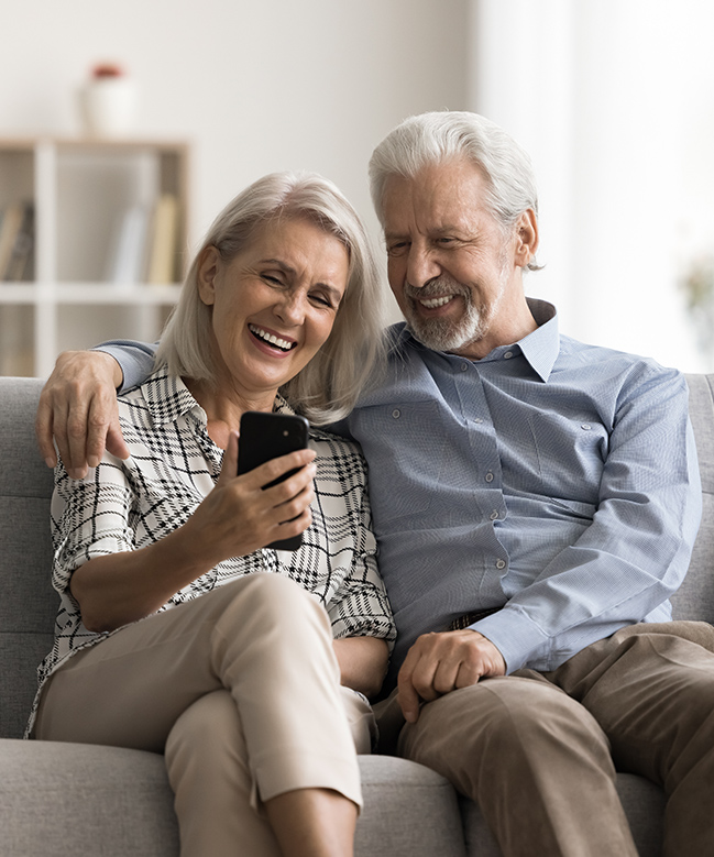 couple smiling at phone