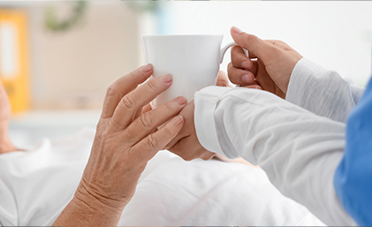 handing over a cup of tea